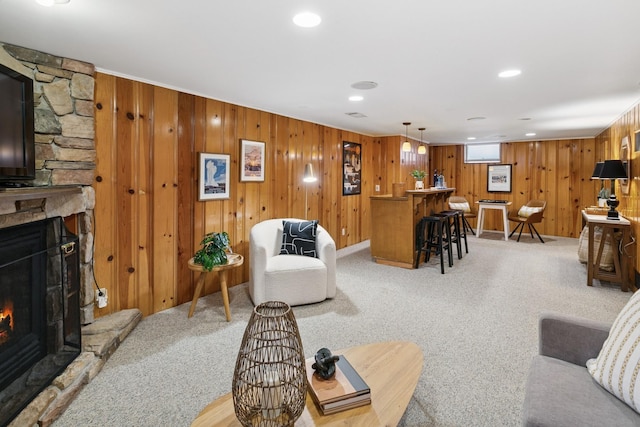 5409 Aldrich Ave S, Minneapolis, MN 55419 - living room with bar, a stone fireplace, light carpet, wooden walls, and recessed lighting