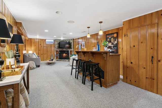 5409 Aldrich Ave S, Minneapolis, MN 55419 - indoor dry bar featuring light carpet, a stone fireplace, wooden walls, and hanging light fixtures