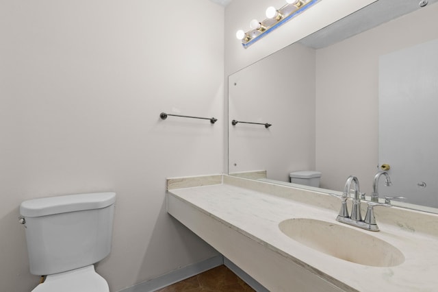 4100 Meadowlark Ln Unit 24100, Eagan, MN 55122 - half bathroom featuring toilet, vanity, and tile patterned flooring
