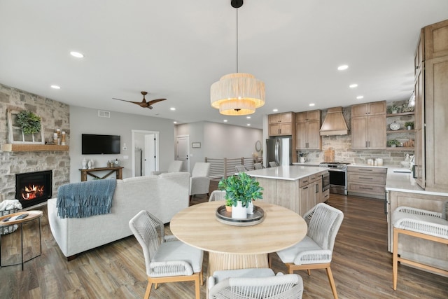 2401 Goldfinch Ln, Buffalo, MN 55313 - dining area featuring dark wood finished floors, recessed lighting, ceiling fan, and a stone fireplace