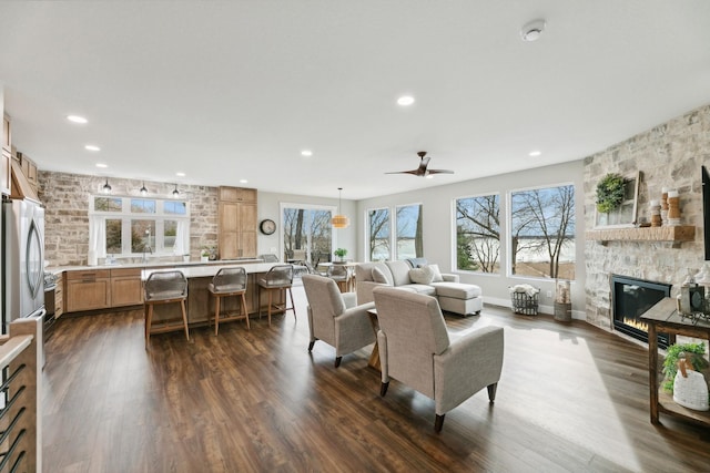 2401 Goldfinch Ln, Buffalo, MN 55313 - living area featuring a stone fireplace, dark wood-type flooring, recessed lighting, and ceiling fan