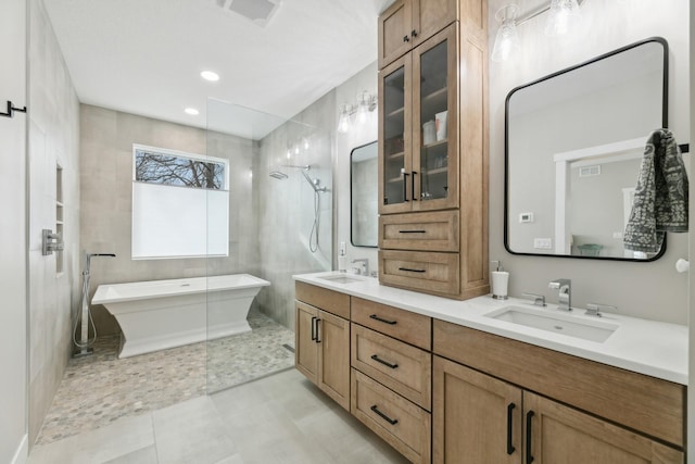 2401 Goldfinch Ln, Buffalo, MN 55313 - full bathroom with double vanity, a soaking tub, a tile shower, tile patterned floors, and recessed lighting