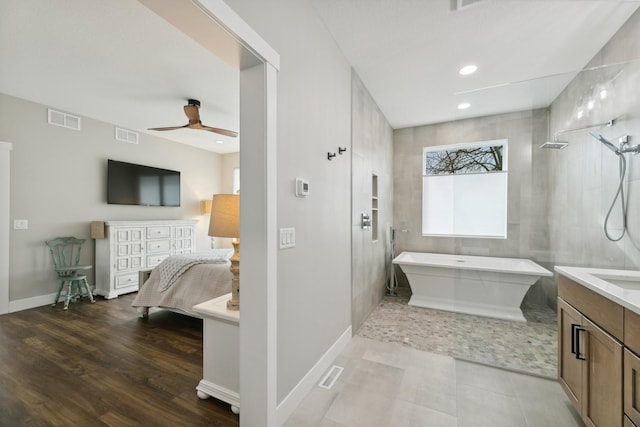 2401 Goldfinch Ln, Buffalo, MN 55313 - full bathroom featuring a ceiling fan, a freestanding tub, vanity, baseboards, and recessed lighting