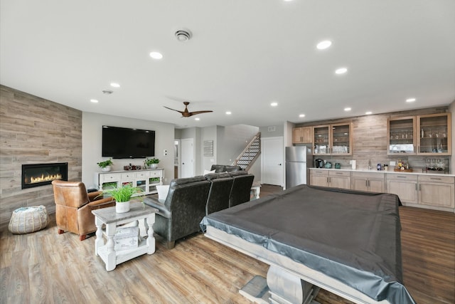 2401 Goldfinch Ln, Buffalo, MN 55313 - living area featuring bar with sink, recessed lighting, billiards, wood finished floors, and a tile fireplace