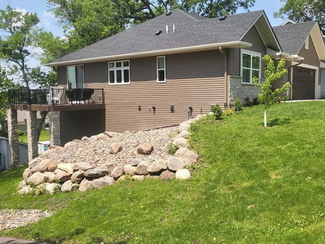 2401 Goldfinch Ln, Buffalo, MN 55313 - view of property exterior featuring a shingled roof, a yard, stone siding, a garage, and a deck