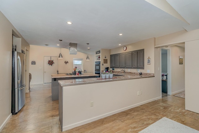 38630 Woodview Ln, Le Center, MN 56057 - kitchen with freestanding refrigerator, a peninsula, light countertops, gray cabinets, and recessed lighting