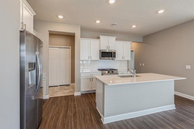10049 73rd Ln NE, Otsego, MN 55330 - kitchen featuring appliances with stainless steel finishes, a sink, dark wood-style floors, baseboards, and white cabinets