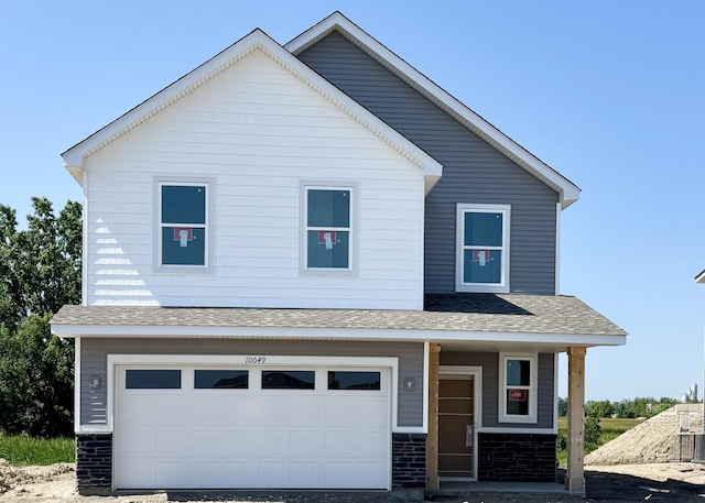 10049 73rd Ln NE, Otsego, MN 55330 - view of front of home featuring a shingled roof, an attached garage, and covered porch