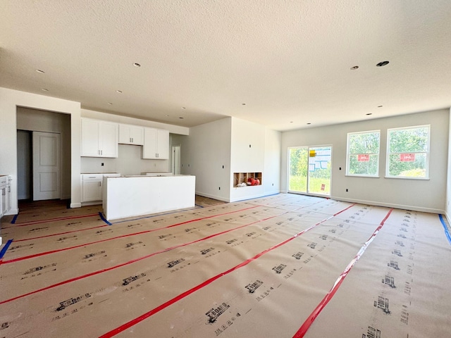 10049 73rd Ln NE, Otsego, MN 55330 - unfurnished living room with a textured ceiling