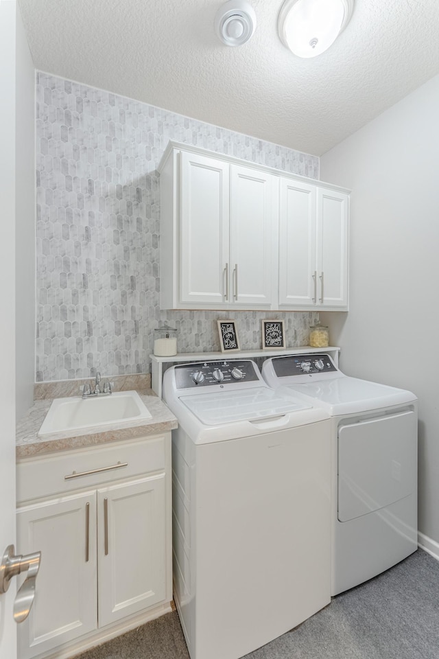 8799 Irving Blvd N, Lake Elmo, MN 55042 - laundry room featuring cabinet space, washer and dryer, and a textured ceiling