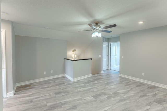 8799 Irving Blvd N, Lake Elmo, MN 55042 - unfurnished room featuring a ceiling fan, a textured ceiling, and baseboards