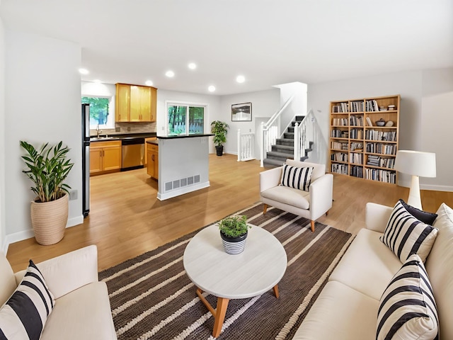 7040 Winfield Rd, Rockford, MN 55373 - living room with light wood-style floors, stairway, recessed lighting, and baseboards
