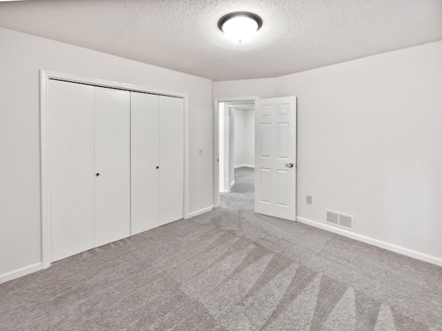 7040 Winfield Rd, Rockford, MN 55373 - unfurnished bedroom featuring a textured ceiling, a closet, carpet, and baseboards