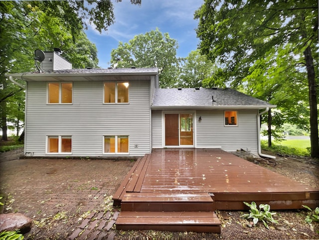 7040 Winfield Rd, Rockford, MN 55373 - rear view of property featuring a chimney, a wooden deck, and a patio
