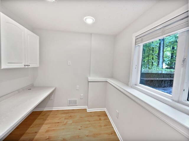 7040 Winfield Rd, Rockford, MN 55373 - laundry room with light wood-type flooring and baseboards