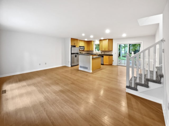 7040 Winfield Rd, Rockford, MN 55373 - kitchen featuring stainless steel appliances, recessed lighting, baseboards, dark countertops, and light wood-style flooring