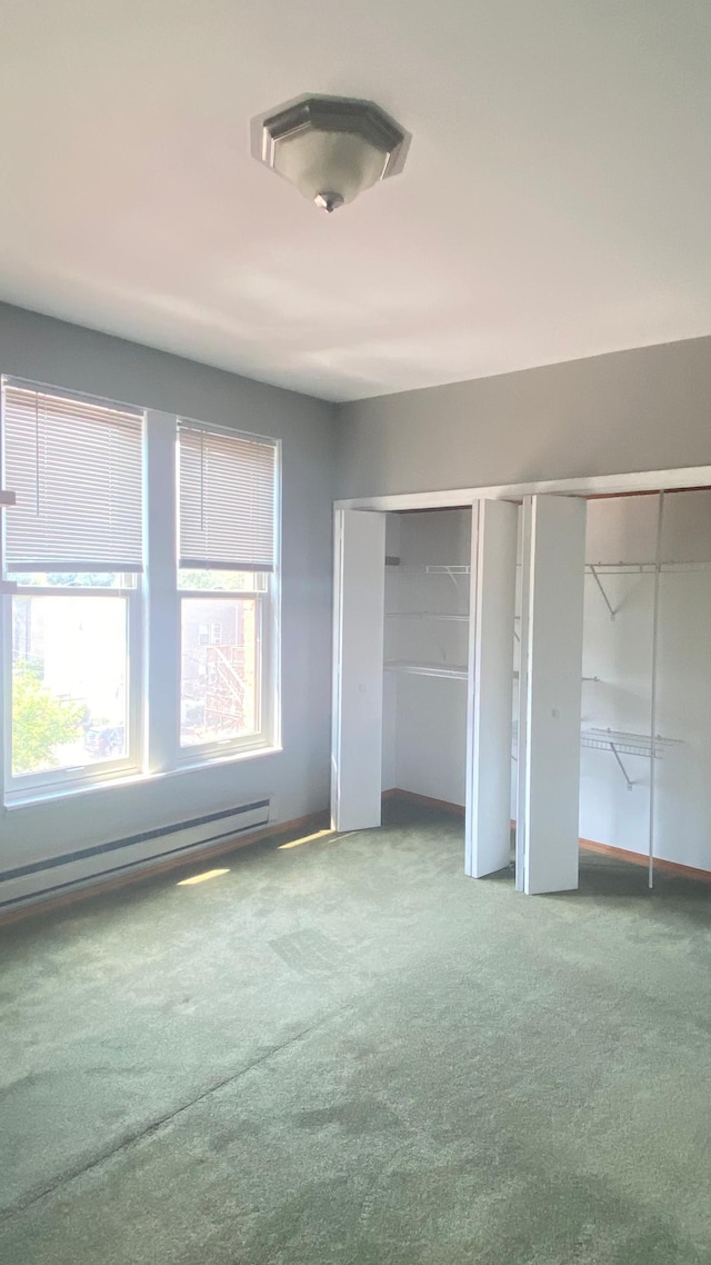 703 Laurel Ave Unit 4W, Saint Paul, MN 55104 - unfurnished bedroom featuring carpet flooring, two closets, a baseboard heating unit, and baseboards