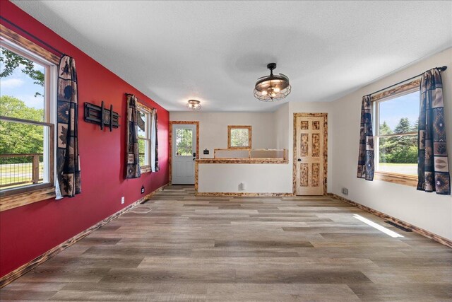 1334 105th Ave, Amery, WI 54001 - unfurnished living room featuring plenty of natural light, wood finished floors, and baseboards