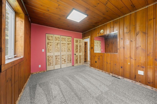 1334 105th Ave, Amery, WI 54001 - empty room with wood ceiling, wooden walls, carpet flooring, and healthy amount of natural light