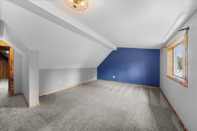 1334 105th Ave, Amery, WI 54001 - additional living space featuring carpet floors, vaulted ceiling, baseboards, and a textured ceiling