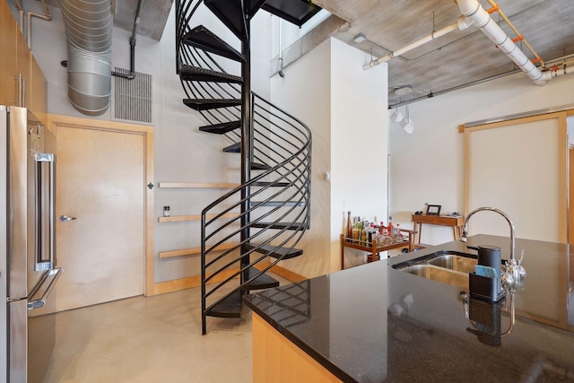 525 3rd St Unit 502, Minneapolis, MN 55401 - kitchen with high end refrigerator, concrete floors, and dark stone counters