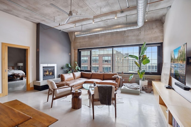 525 3rd St Unit 502, Minneapolis, MN 55401 - living area with a high ceiling, plenty of natural light, finished concrete floors, and a glass covered fireplace