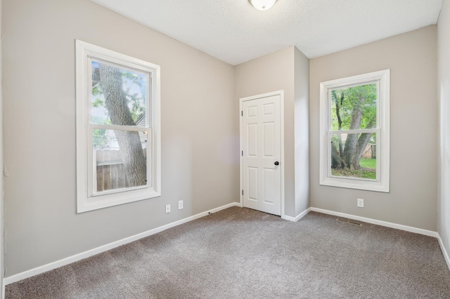 2619 23rd Ave N, Minneapolis, MN 55411 - unfurnished bedroom featuring carpet and a textured ceiling