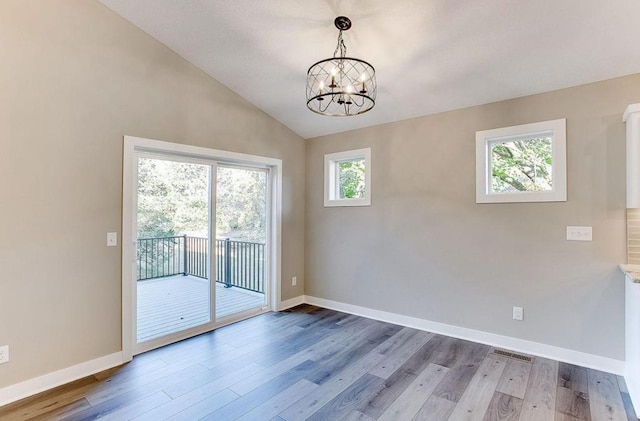 12620 Overlook Rd, Dayton, MN 55327 - unfurnished room with wood finished floors, a chandelier, baseboards, and lofted ceiling