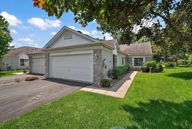 9479 Prairieview Trl N, Champlin, MN 55316 - single story home featuring asphalt driveway, a front yard, brick siding, and an attached garage