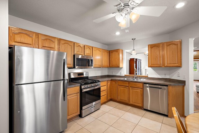 9479 Prairieview Trl N, Champlin, MN 55316 - kitchen featuring stainless steel appliances, a sink, dark countertops, a ceiling fan, and light tile patterned floors
