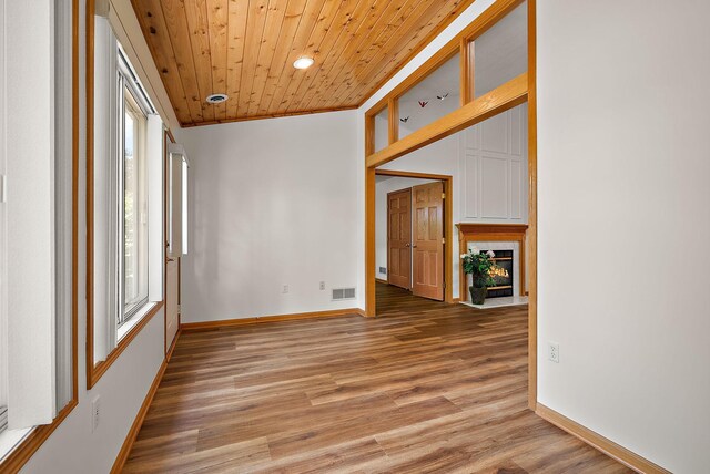 9479 Prairieview Trl N, Champlin, MN 55316 - spare room with wooden ceiling, light wood-type flooring, a large fireplace, baseboards, and recessed lighting