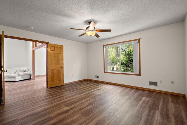 9479 Prairieview Trl N, Champlin, MN 55316 - unfurnished room featuring dark wood-style flooring, ceiling fan, baseboards, a textured ceiling, and a smoke detector