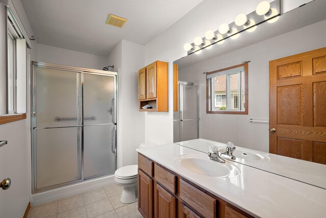 9479 Prairieview Trl N, Champlin, MN 55316 - bathroom with vanity, a stall shower, toilet, and tile patterned floors