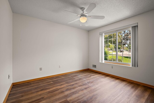 9479 Prairieview Trl N, Champlin, MN 55316 - unfurnished room featuring wood finished floors, baseboards, a ceiling fan, and a textured ceiling