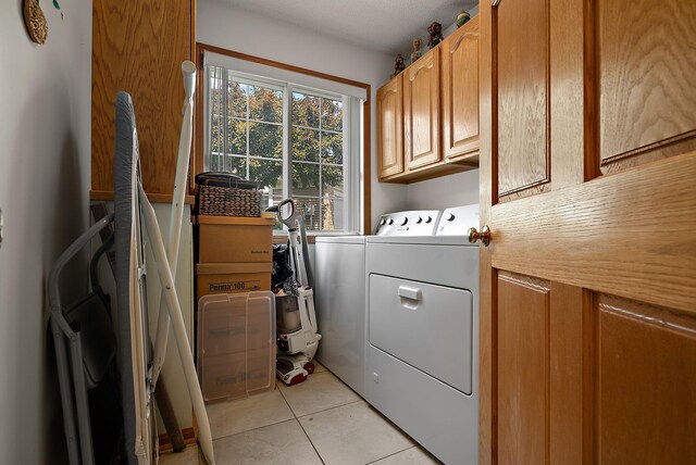 9479 Prairieview Trl N, Champlin, MN 55316 - washroom featuring cabinet space, washing machine and clothes dryer, and light tile patterned floors