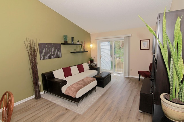 653 86th Ln NW, Coon Rapids, MN 55433 - living area featuring light wood-style flooring and vaulted ceiling