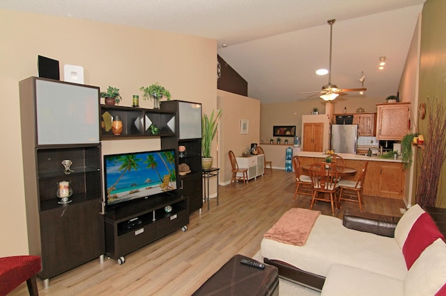 653 86th Ln NW, Coon Rapids, MN 55433 - living area featuring light wood-type flooring, ceiling fan, and vaulted ceiling