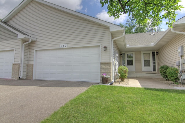 653 86th Ln NW, Coon Rapids, MN 55433 - view of front of property featuring a garage, brick siding, a front yard, and driveway