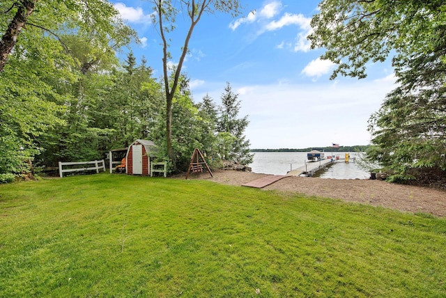 22946 185th St NW, Orrock Twp, MN 55309 - view of grassy yard with a water view, a boat dock, and a storage shed