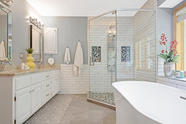 22946 185th St NW, Orrock Twp, MN 55309 - full bath featuring a soaking tub, a stall shower, double vanity, tile walls, and tile patterned floors