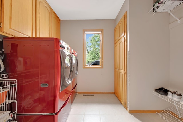 22946 185th St NW, Orrock Twp, MN 55309 - laundry area with cabinet space, washer and dryer, and light tile patterned floors