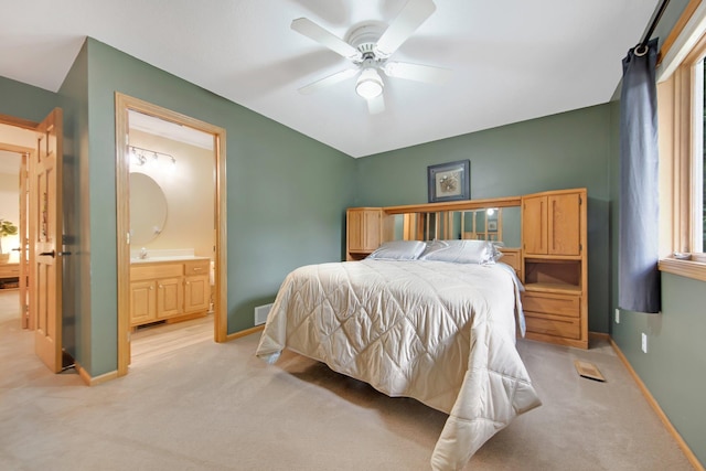 22946 185th St NW, Orrock Twp, MN 55309 - bedroom with light carpet, connected bathroom, and a ceiling fan