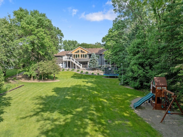22946 185th St NW, Orrock Twp, MN 55309 - view of green lawn featuring a trampoline, a playground, and stairway