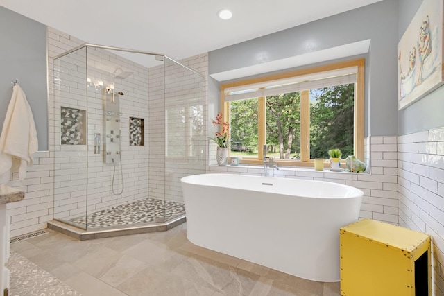 22946 185th St NW, Orrock Twp, MN 55309 - full bathroom featuring a freestanding tub, tile walls, a shower stall, recessed lighting, and a chandelier