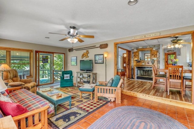 45909 Lands End Rd, Vergas, MN 56587 - tiled living area with ceiling fan and a stone fireplace