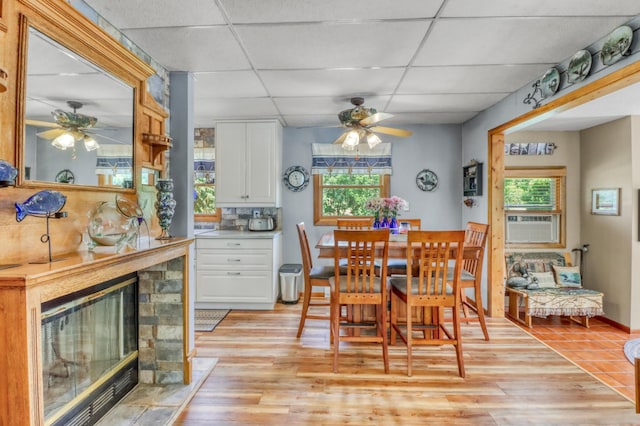 45909 Lands End Rd, Vergas, MN 56587 - dining space featuring a ceiling fan, a drop ceiling, light wood-style floors, and plenty of natural light