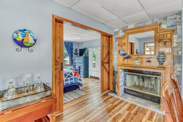 45909 Lands End Rd, Vergas, MN 56587 - living area featuring a drop ceiling, wood finished floors, and a glass covered fireplace