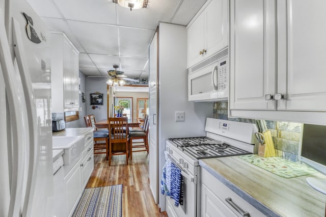 45909 Lands End Rd, Vergas, MN 56587 - kitchen featuring white appliances, a paneled ceiling, white cabinets, light wood finished floors, and light countertops
