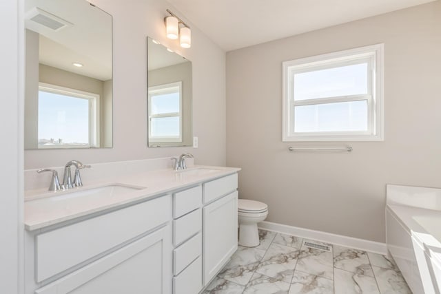 8335 Lander Ave NE, Otsego, MN 55330 - bathroom with double vanity, marble finish flooring, baseboards, toilet, and a bathtub
