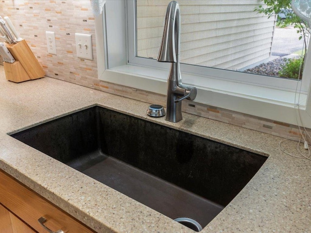 8025 Dalton Rd, Baxter, MN 56425 - kitchen view of a sink, backsplash, and light stone countertops
